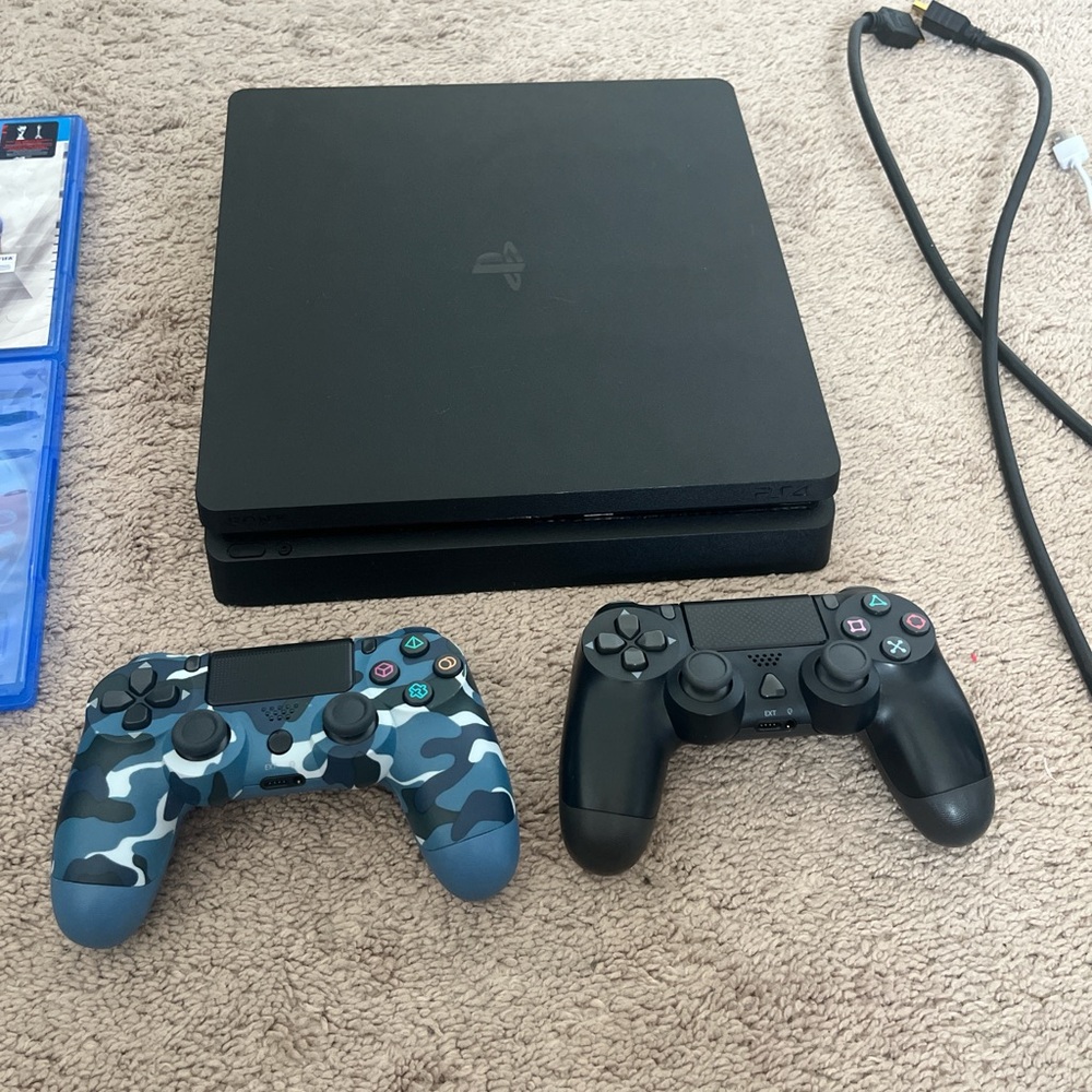 Sony PlayStation Console with Black and Blue Camouflage Controllers